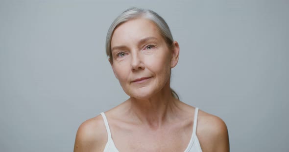 A Senior Age Model Without Makeup Posing Looking at the Camera