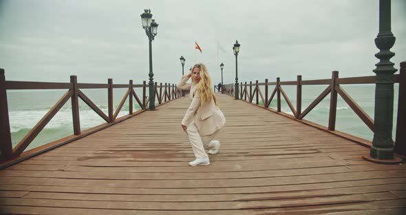 Dancer Performing Cartwheel On Seaside Pier