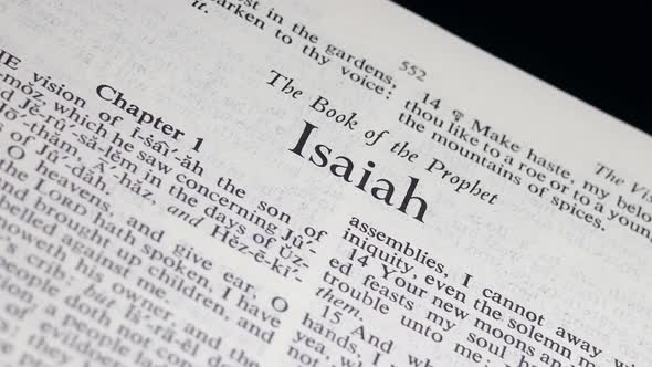 Close Up Bible Page Turning to the book of Isaiah