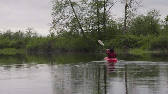 Adventure Caucasian Adult Woman Kayaking in Red Kayak