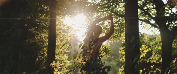 Man stretches while in forest