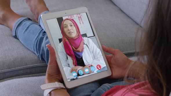 Woman talking on video meeting on her digital tablet