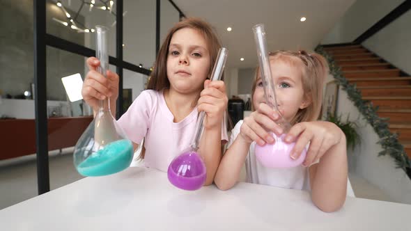 Little Girls Making Chemical Experiments at Home