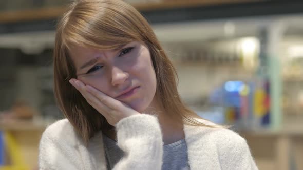 Headshot of Young Woman with Tooth Infection Toothache