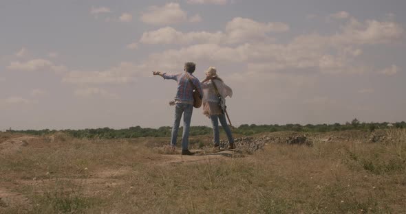 Musicians Look Around on a Meadow