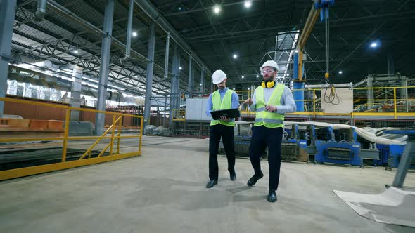 Modern Factory Workers Walk in a Facility