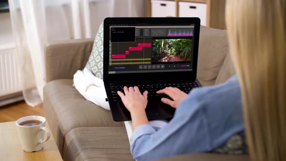 Woman with Video Editor Program on Laptop at Home 