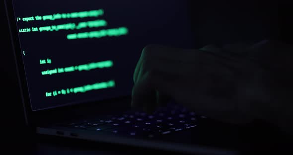 Hacker hands typing on a keyboard, close up view