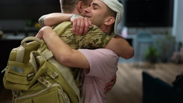 Portrait of Excited Caucasian Gay Man Meeting Partner Returning Home From Army