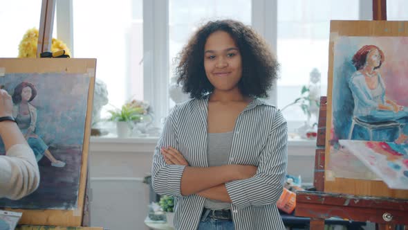 Portrait of Art School Model African American Girl Smiling in Class While Students Painting