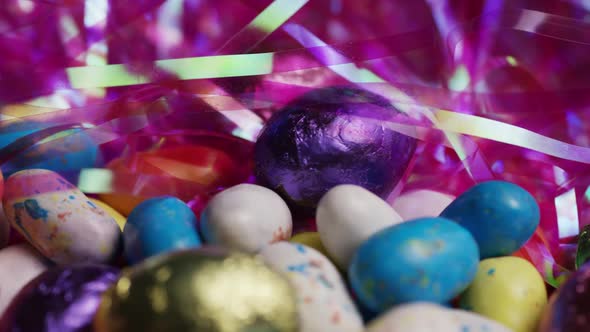 Rotating shot of colorful Easter candies on a bed of easter grass