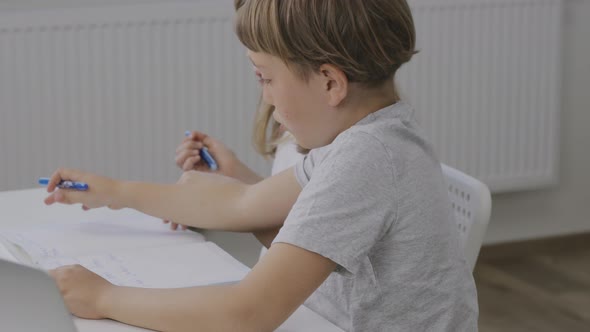 Brother Helps His Younger Sister to Make Her Homework