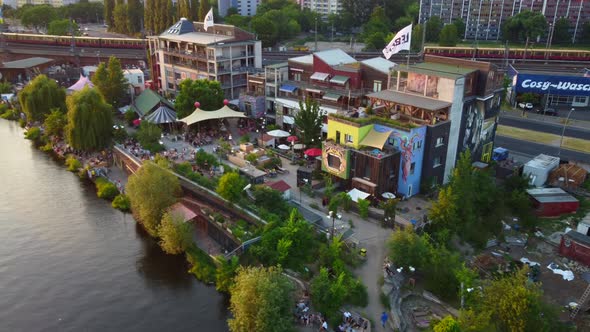 Drone shot of Holzmarkt in Berlin - drone is passing by while facing the hip collective of ateliers,