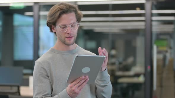 Portrait of Young Businessman Reacting to Loss on Tablet