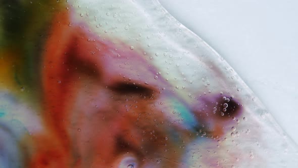 Transparent Space Liquid is Filled with Drops of Red Blue Yellow and Green Paint