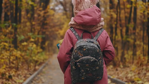 School Girl Walking in Autumn Park