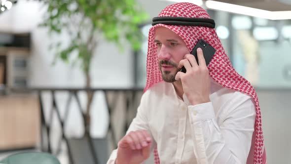 Arab Businessman Celebrating Success on Smartphone