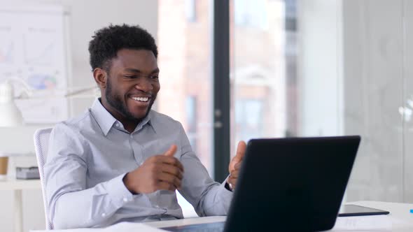 Businessman Having Video Chat on Laptop at Office