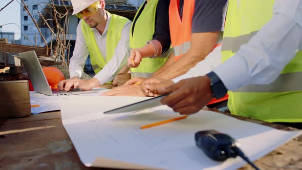 Group of Diverse Specialists at Construction Site