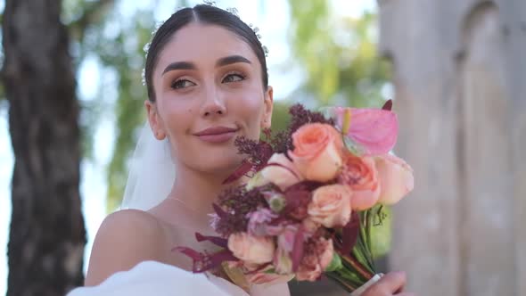 Closeup Profile Shot of a Bride Admiring a Bouquet of Flowers