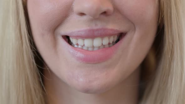 Close Up of Smiling Lips of Young Woman