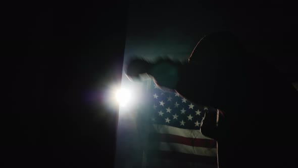 A Young Man Boxing a Pear in the Spotlight in the Background of the U