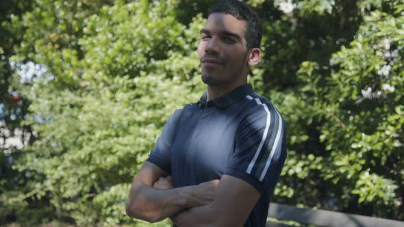 Man with Crossed Arms Looking at Camera, Being Serious