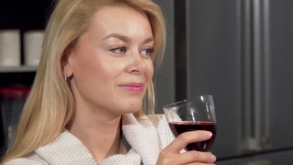 Happy Beautiful Woman Smiling To the Camera, Enjoying Drinking Wine at Home