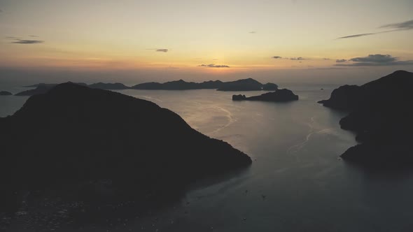 Mountain Island Silhouette at Ocean Bay Sunset Slow Motion Aerial View