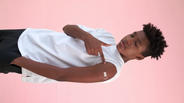 Vertical Video of African Teenager Showing COVID19 Vaccine Bandage Merrily