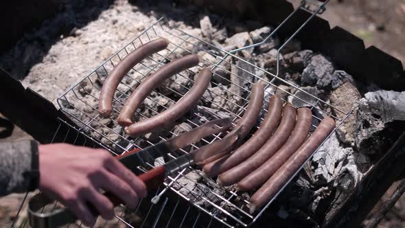 Closeup View of Tasty Sausages Grilling on Charcoal Grill Grate