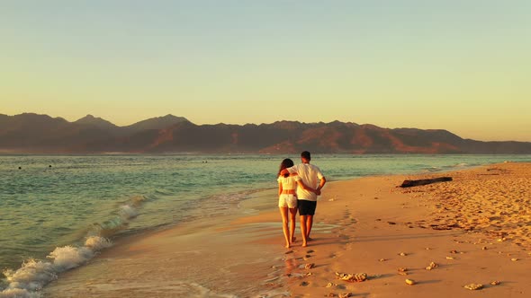 Happy people on romantic honeymoon enjoy luxury on beach on white sand background 