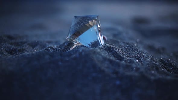 Crystal lit by moonlight on the beach