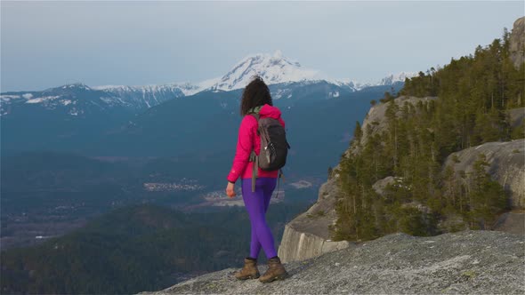 Adventurous Girl Hiking on Top of a Peak