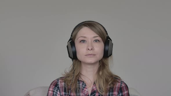 Portrait of Cute Cheerful Caucasian Girl Agreeing with Something and Showing Thumbs Up at Camera