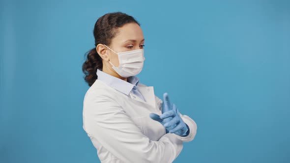 Confident Female Doctor in Protective Medical Face Mask Coming Into Shot and Looking at Camera with