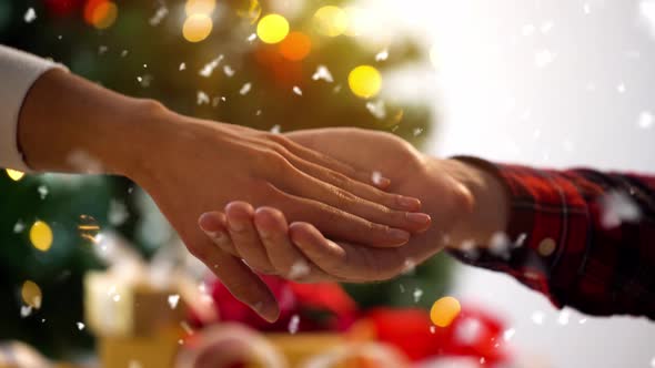 Hands of Couple with Diamond Ring on Christmas