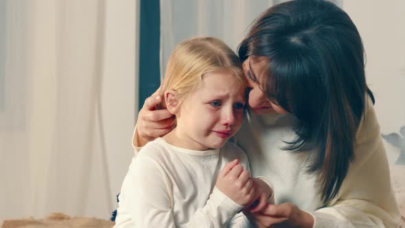 Mom Soothes Her Little Daughter Who Is Crying a Lot