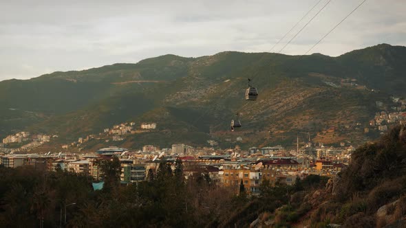 Cable car cabin going down from mountains with cityscape Alanya Turkey