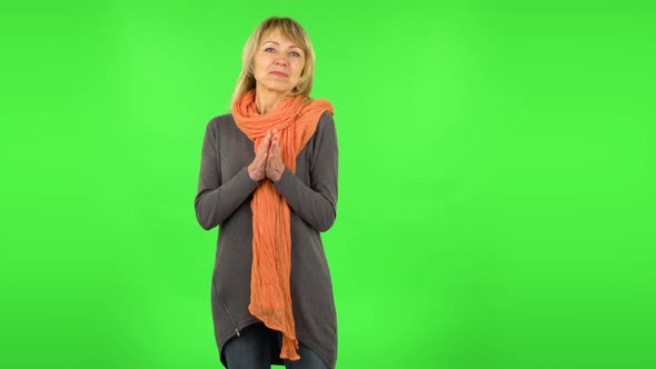 Middle Aged Blonde Woman Is Waiting in Anticipation with Pleasure. Green Screen