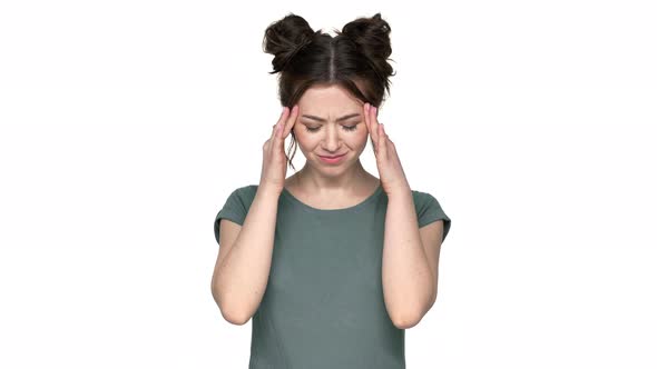 Portrait of Tired Woman 20s with Double Buns Hairstyle Suffering From Strong Headache and Massaging