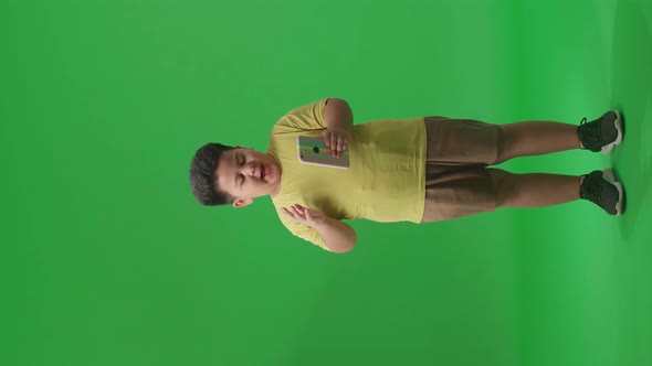 Full Body Of Young Asian Little Boy Surprise And Say Wow During Use Mobile Phone On Green Screen