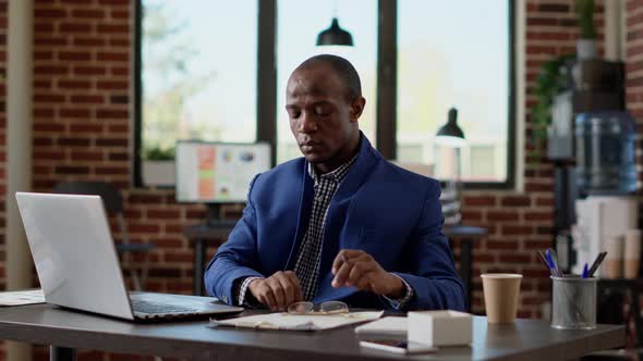 Male Consultant Using Paperwork to Develop Business Strategy