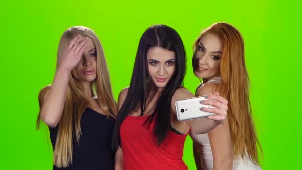 Girls Pose for the Camera of the Smartphone