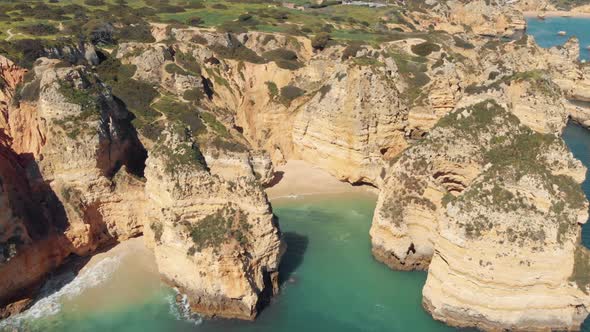 Isolated Grotto beach surrounded by Nature eroded Cliffs of Ponta da Piedade, Lagos, Algarve