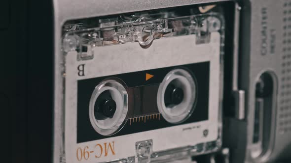 Audio Cassette in the Tape Recorder Playing and Rotates