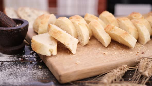 Sliced Fresh Baguette Bread on Wooden Cutting Board