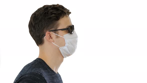 Blind Man Walking in Medical Mask and Dark Glasses on White Background