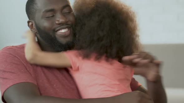 African Man Hugging His Cute Daughter and Smiling, Parenthood, Family Comfort