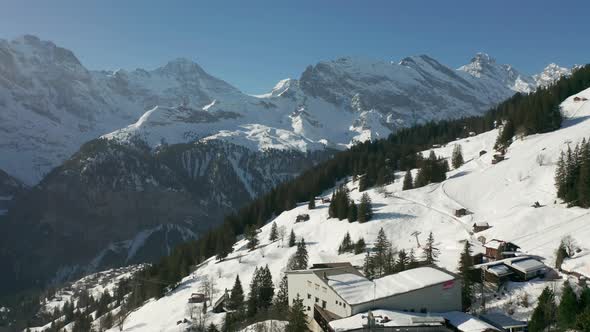 Aerial jib up of beautiful snow covered Swiss landscape